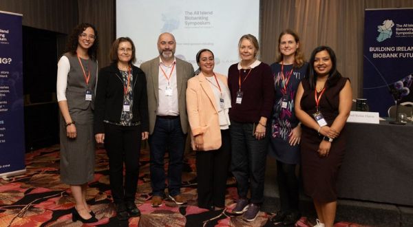group of people posing for a photo at a conference