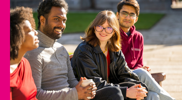 Postgraduate students talk together in a casual outdoor setting in the Quadrangle, University of Galway