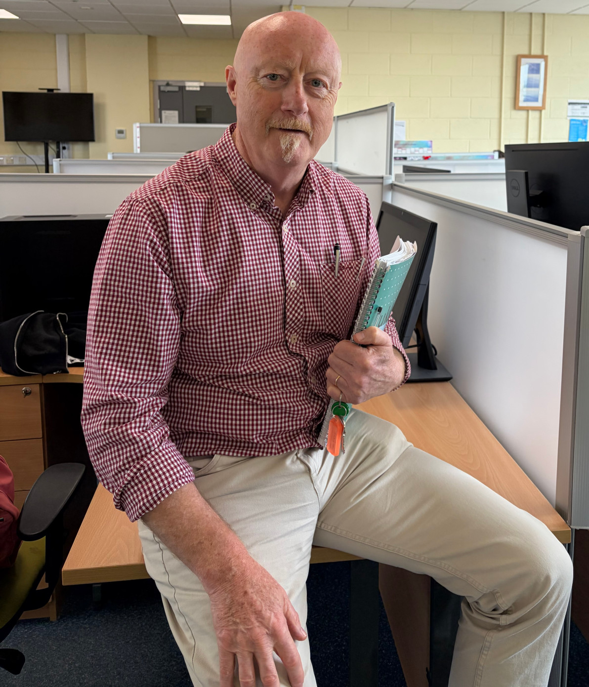 Prof John Pius Dalton posing for a picture in the office