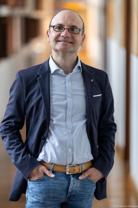 Jordi Sanchez posed wearing blue shirt and grey jacket