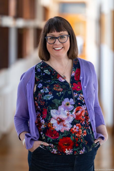 Lindsay Reid posing in purple cardigan