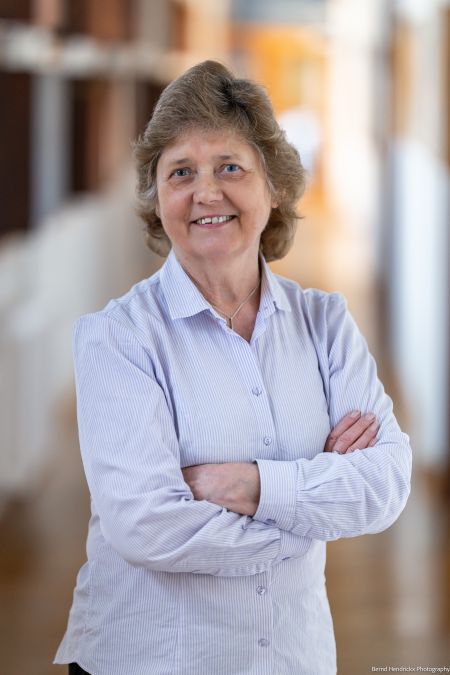 Marianne Ailes standing with arms folded