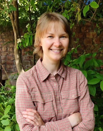 Alena Minko outdoors with arms folded