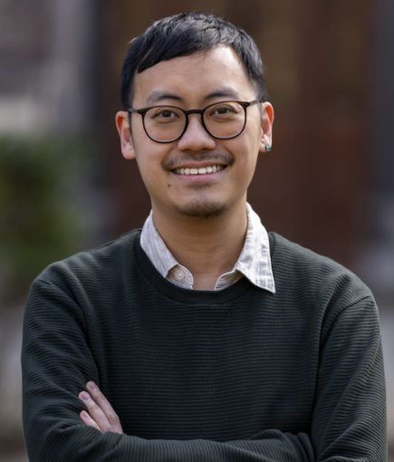 Ian Wong outdoors standing with arms folded