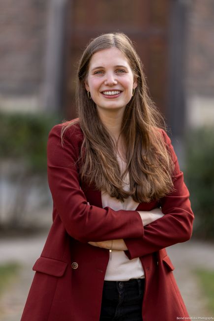 Laurie Hoeben outdoors standing with arms folded