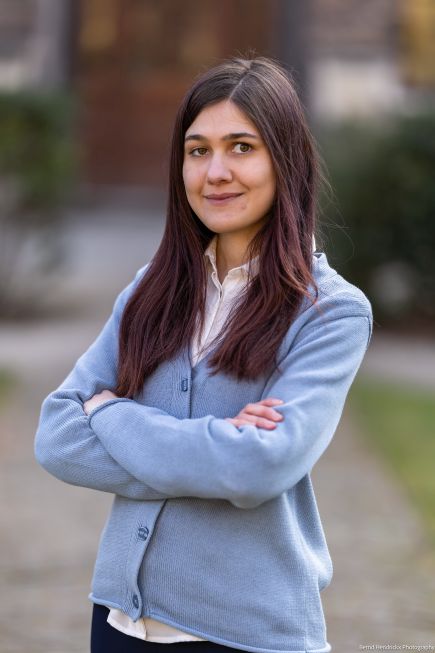 Melania Mara outdoors standing with arms folded