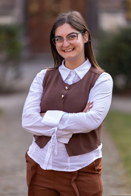 Sara D'Amico outdoors standing with arms folded