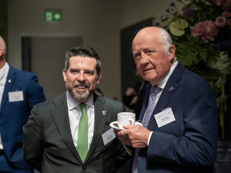 graduate pictured with previous head of college