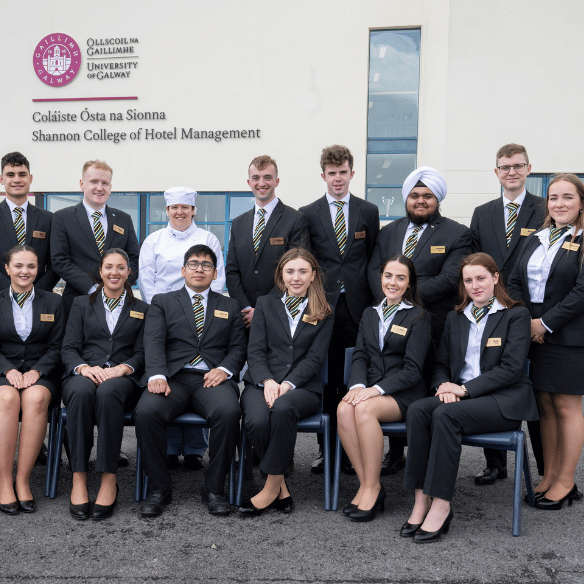 Students outside the college smiling in uniform